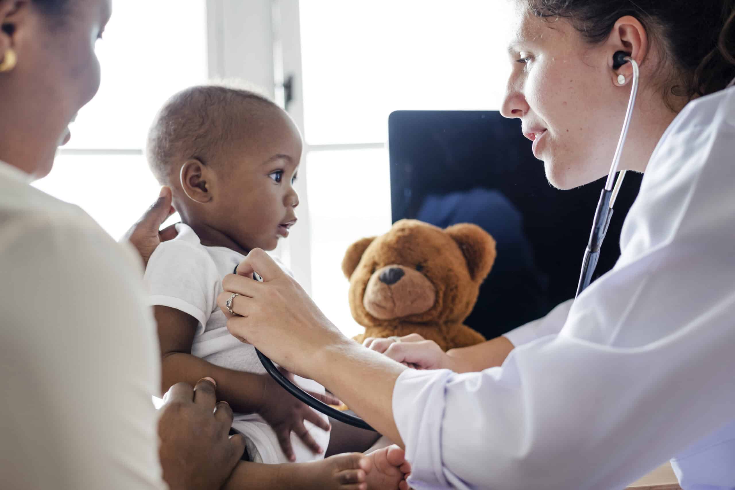 Doctor checking a baby's temperature during a sick visit at Valcourt Pediatrics