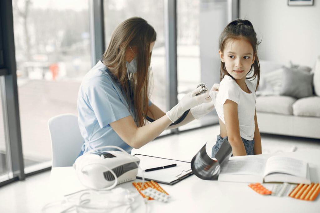 nurse and little girl Child receiving vaccination at Valcourt Pediatrics