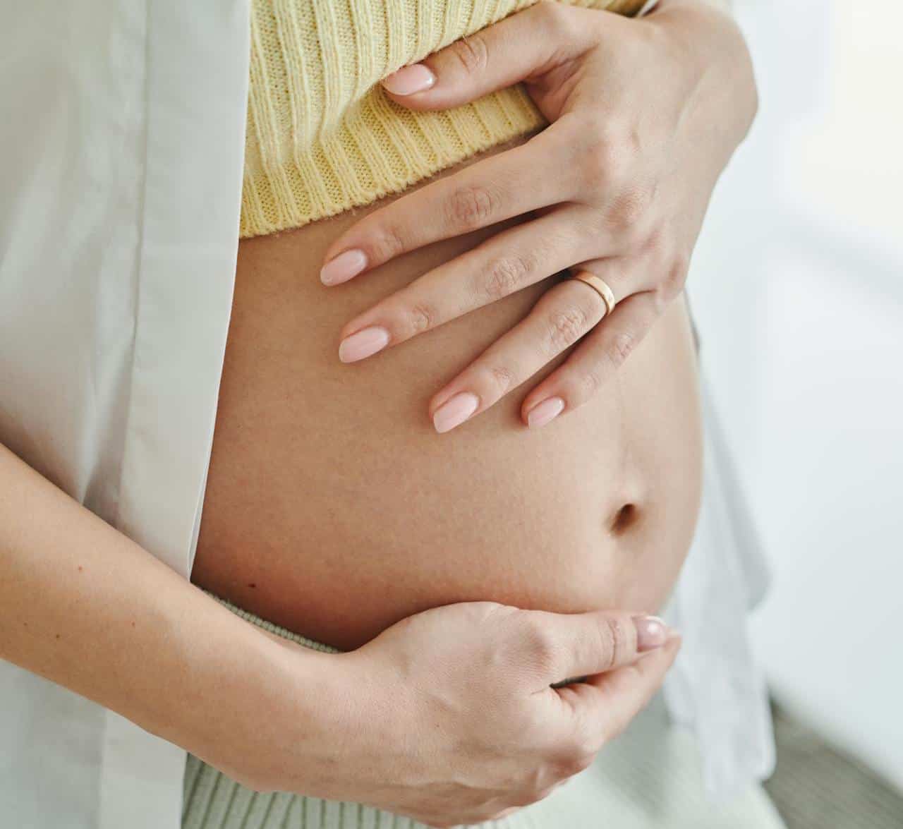pregnant mother holding her belly