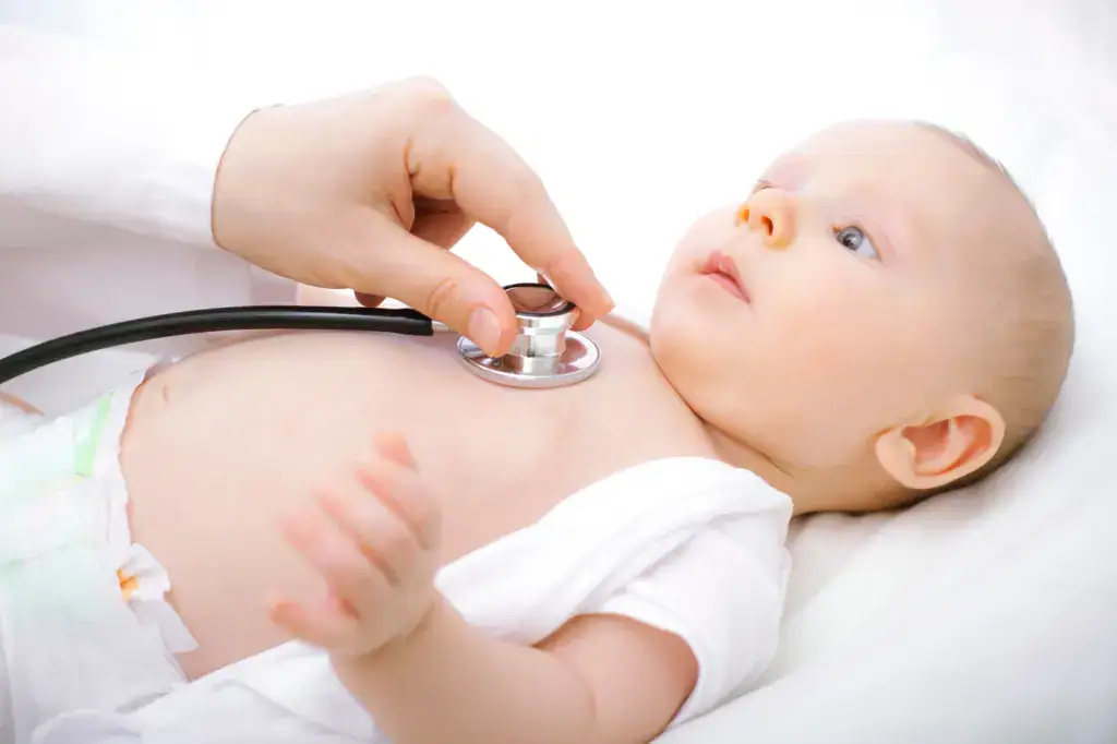 Newborn baby receiving a pediatric examination.